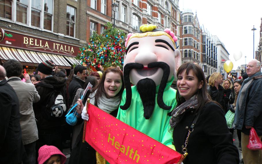 Passers-by at the Chinese New Year festival in London pose with a Chinese figure during celebrations on Feb. 6.