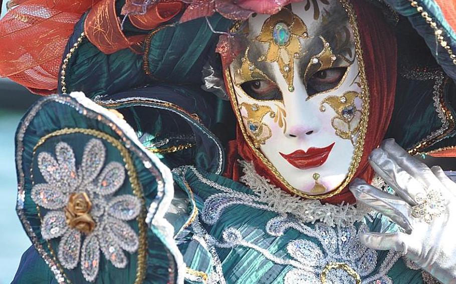 Some of those dressed up in Venice's annual Carnevale celebration obviously have experience posing for pictures. The posers are generally surrounded by photographers after staking out strategic locations near St. Mark's Square.
