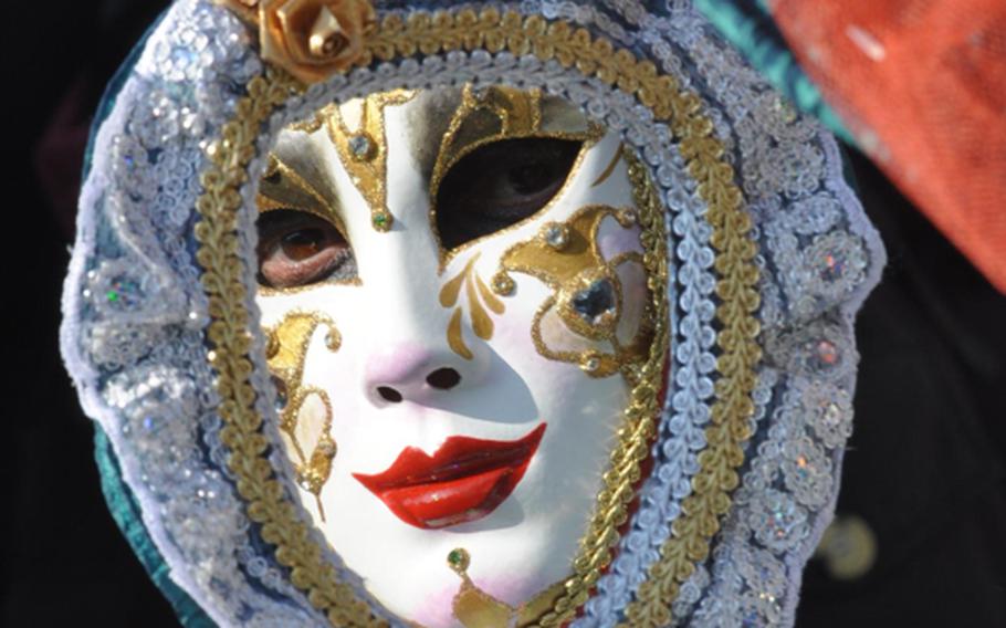 I see you! Some of those in costumes at Venice's Carnevale celebration are not only dressed from head to toe -- they carry  scepters, medieval weapons and mirrors to enhance and touch up their look.