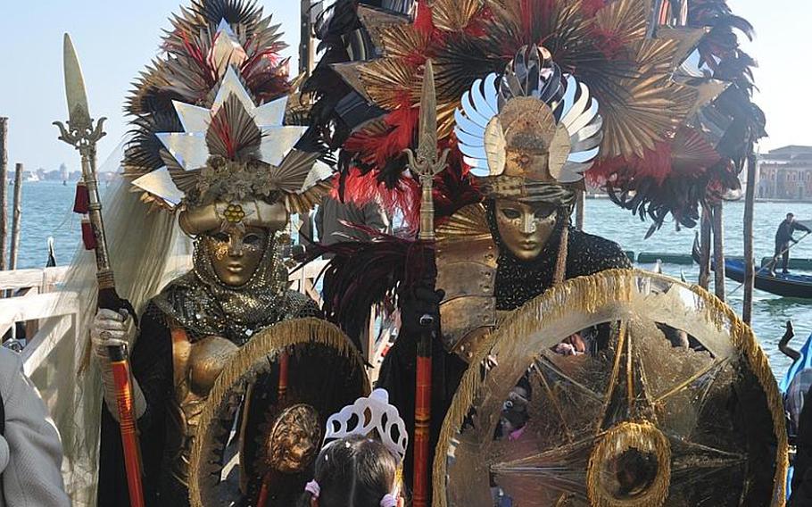 Fortunately, you don't have to get past this pair of martial-looking revelers to get onto a gondola during Carnevale in Venice, Italy. You do have to have at least 80 euros for a ride. The pictures are free, though.
