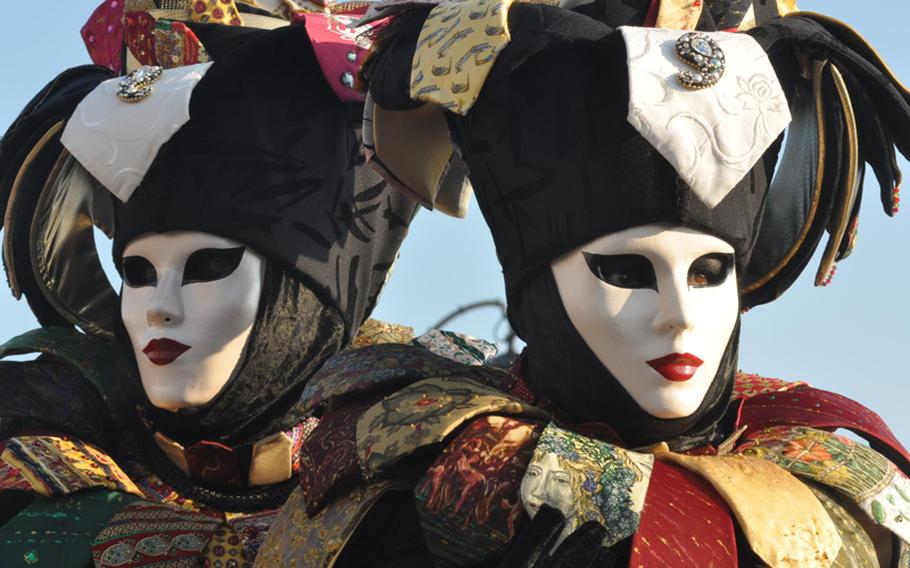 Sometimes those wearing costumes at Venice's Carnevale celebration dress up in pairs, such as this couple holding court near the Grand Canal.
