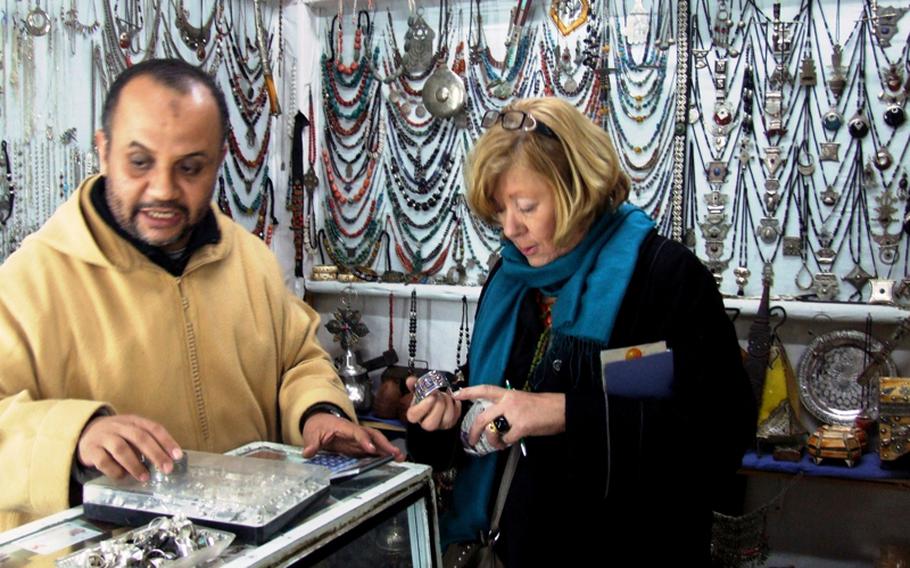 Isabel, one of the women on the trip to Morocco, inspects a silver bracelet. She was the necklace queen, having purchased many during the trip.
