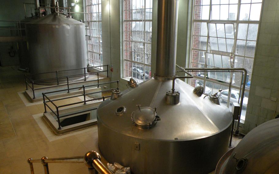 Large stainless steel and copper mash tuns inside the Greene King brewery in Bury St. Edmunds, England, are used as part of the brewing process for ales.