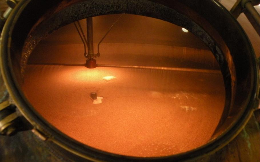 A view inside a large copper tank at the Greene King Brewing Co. in Bury St. Edmunds, shows how barley grist is mixed with hot water to create mash. The liquid is then drained away, at which point it&#39;s called sweet wort.