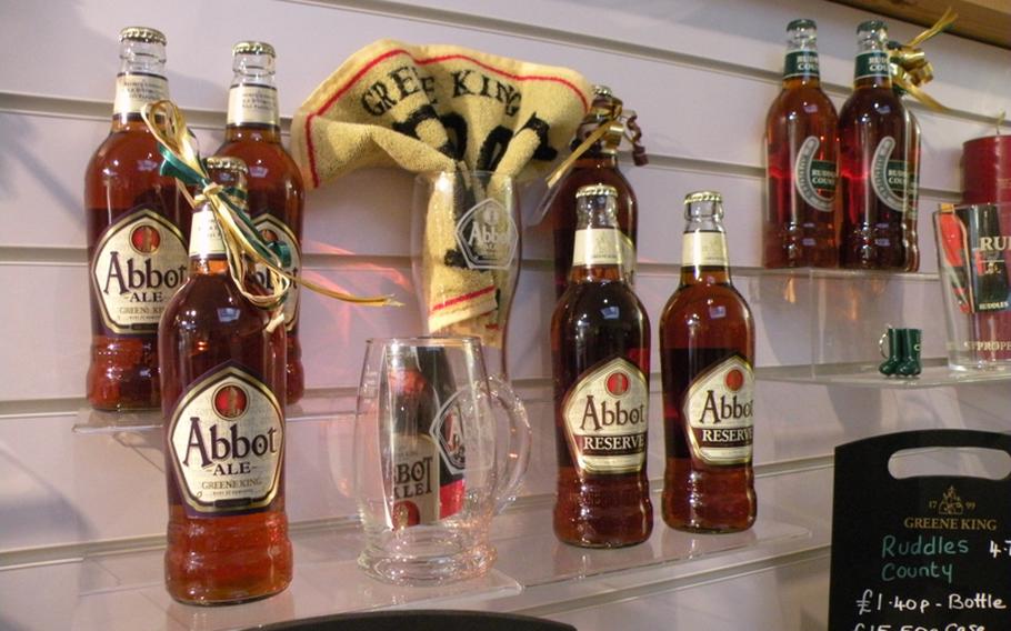 A display in the visitors center at the Greene King Brewing Company in Bury St. Edmunds, England, offers a couple of collectible beer mugs, a bar towel and two Abbot Ale beer brands.