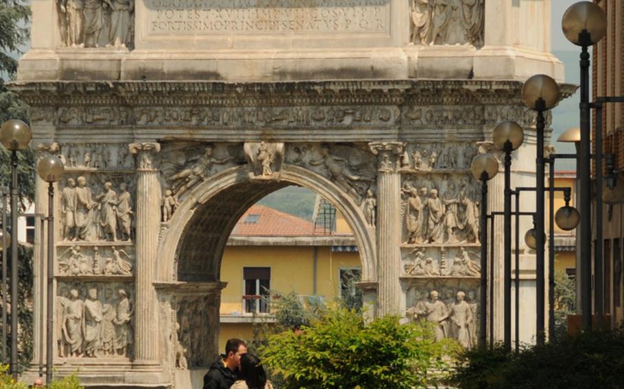 A couple shares a good-bye kiss in front of the famed L&#39;Arco di Traiano in Benevento, southern Italy