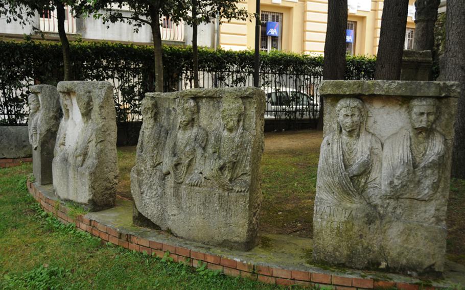 Artifacts from the cloisters of Santa Sofia church are on display outdoors next to the building.