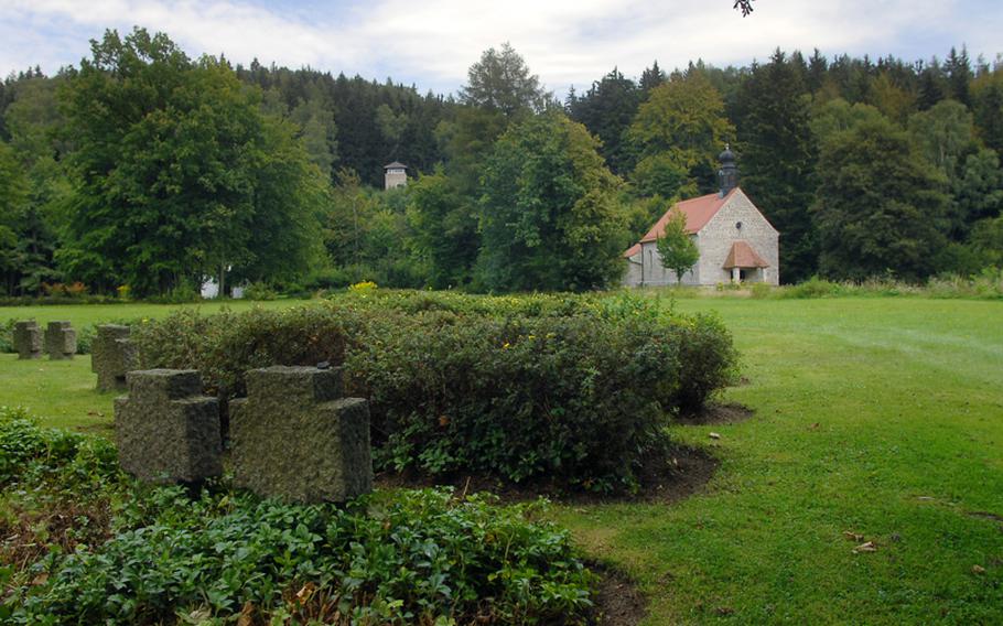 Some 5,000 bodies are buried at KZ-Gedenkstaette Flossenbuerg, a memorial on the site of a former concentration camp in northeast Bavaria. In this photo, an original guard tower is visible on the hillside in the background, as is a chapel built later on the site.