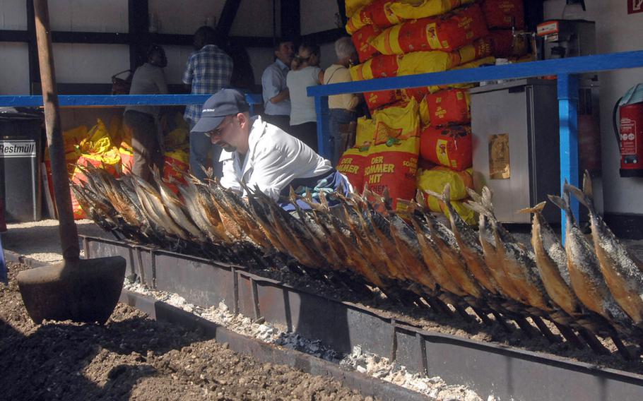 Steckerlfisch - fish grilled on a stick - are ready for hungry customers  at Oktoberfest in Munich. The festival features a wide array of foods, including chicken, sausages and pork knuckles.