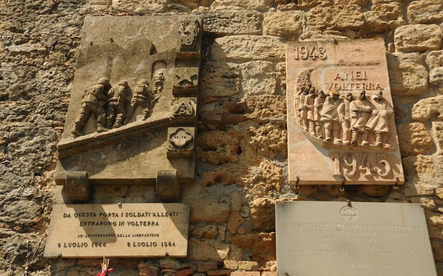 Decorating the old city walls are tribute plaques to soldiers from Voterra, Italy, who died in World War II.