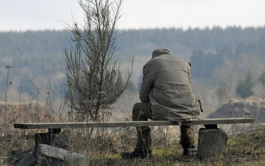 A visitor pauses on one of the trails overlooking a lake at Stöffel Park in Enspel, Germany. Guests can traverse down different paths to explore the area's industrial and geological history as well as its environment.