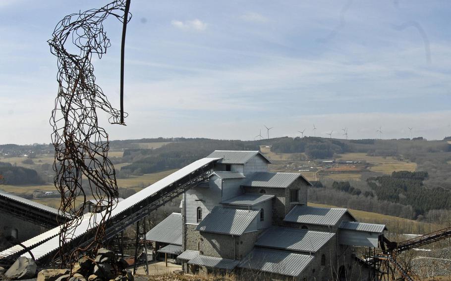 A sculpture honoring the area's industrial workers and history sits atop a hiking trail overlooking Stöffel Park in Enspel, Germany. The park offers visitors a chance to explore industry, geology and nature in an unusual venue.