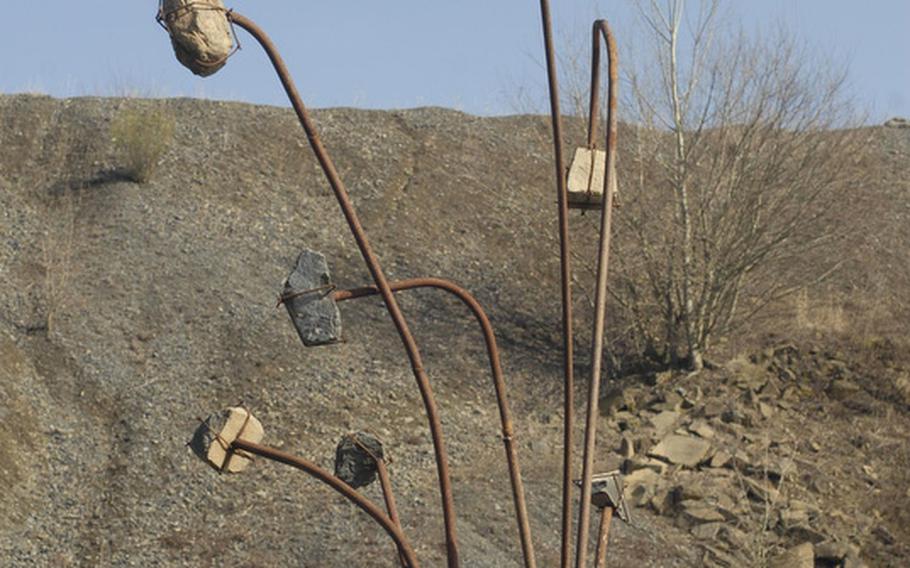 A scultpure symbolizing the area's once-important basalt industry, sits along Stöffel Park's barefoot path in Enspel, Germany.