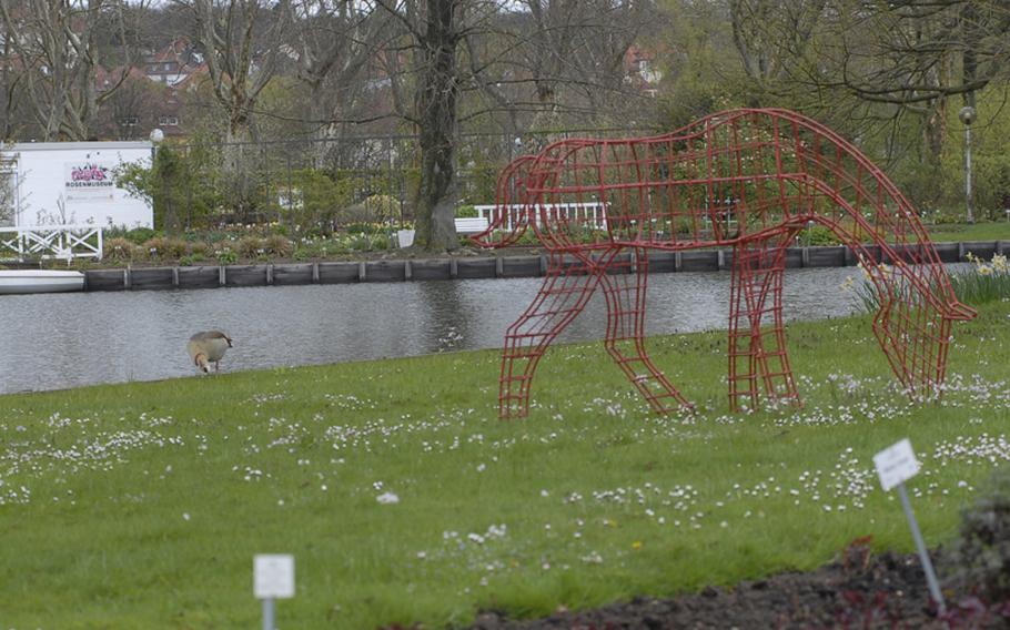 A live goose joins a not-so-live horse for a snack on the lawn at the Rose Garden in Zweibrücken, Germany.