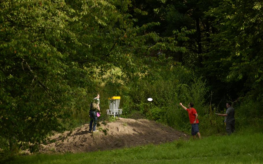A group of disc-golfers finish a hole at the Dynamikum disc golf course in Pirmasens, Germany.