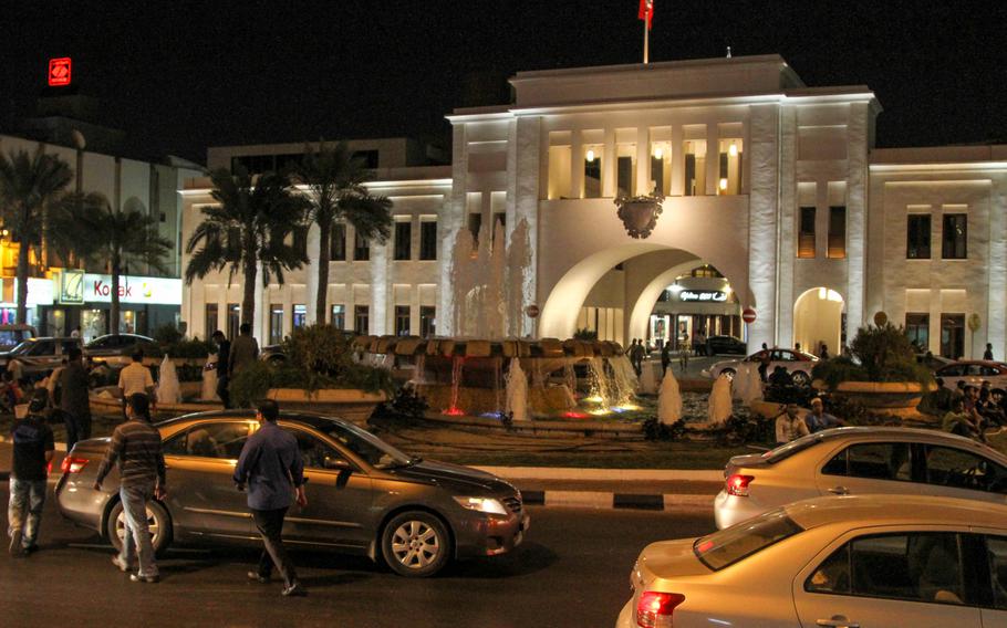 The Bab al-Bahrain (Gateway of Bahrain) in central Manama, Bahrain, is a grand historical building with a bubbling fountain before it and an arch marking the entrance to the Manama Souq.