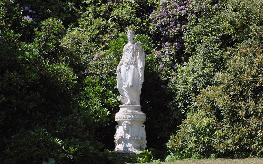 A statue is nestled in the trees around the palace lawn at Bergpark Wilhelmshöhe in Kassel, Germany. Though some of the park's features were under renovation in June 2015, the site still has plenty to offer visitors.