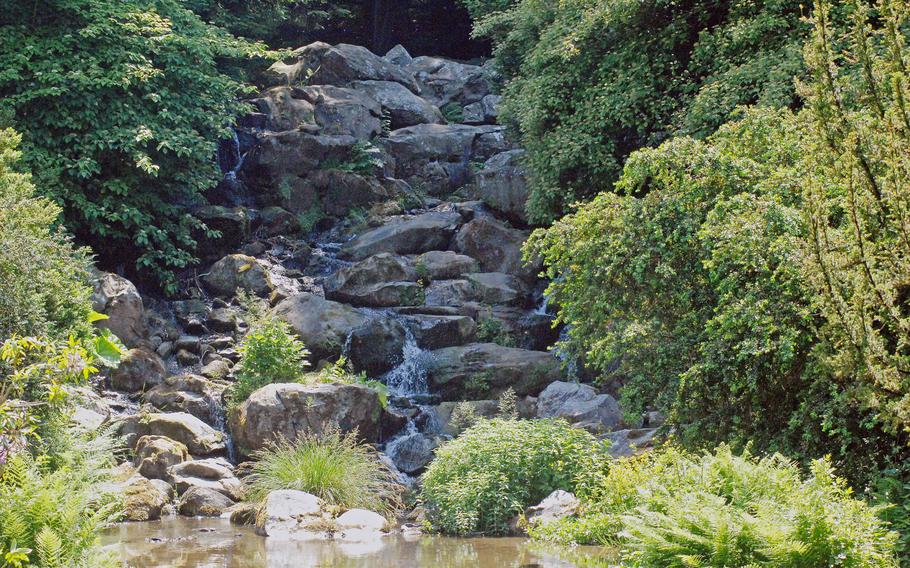 A waterfall tumbles over rocks at Bergpark Wilhelmshöhe in Kassel, Germany. The park is a UNESCO World Heritage site.