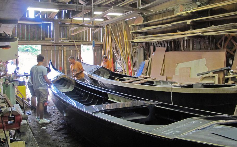 Boat wrights work on gondolas in one of Venice's few remaining boat yards, on San Trovaso Square in the Dorsoduro district.