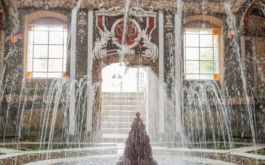 The inner courtyard of the Old Palace at the Gardens of the Hermitage in Bayreuth, Germany, has a fountain with a floating candelabrum that is unlike anything else in the area.