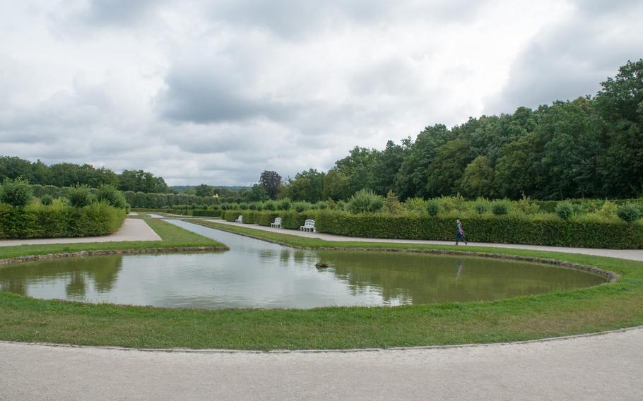 The reflecting pool in the newer hedge gardens at the Gardens of the Hermitage in Bayreuth, Germany, stretches the length of a walking path toward the palaces.