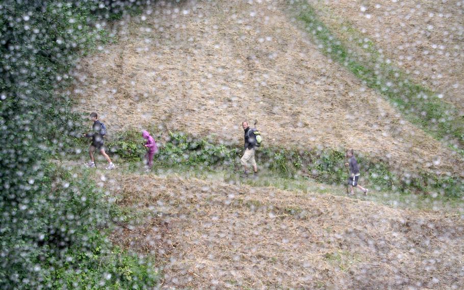 A family of hikers, seen from a cable car above, walks the trail up the Schauinsland mountain on a rainy August day in Germany's Black Forest . Visitors can either hike or take a cable car to the top of the 4,000-foot mountain.