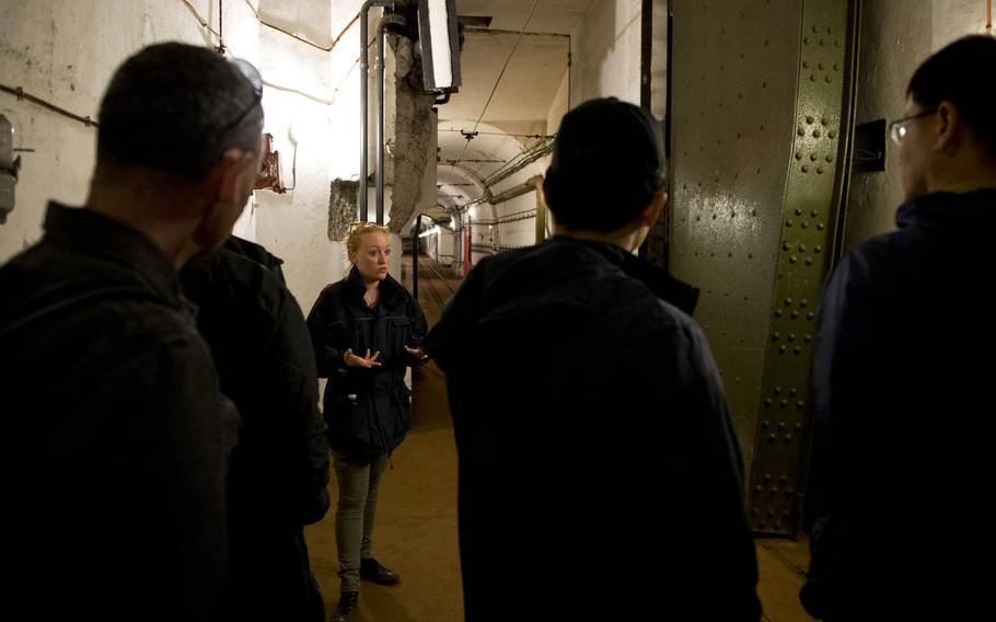 Sarah Weber, a guide at Fort Hackenberg, shows visitors an 8-ton blast door. Fort Hackenberg, near Veckring, France, is the largest among a series of underground fortifications known as the Maginot Line.