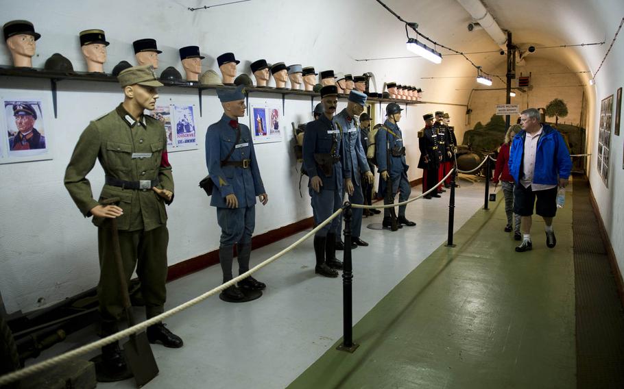 Visitors to Fort Hackenberg, France, view a collection of uniform items used by various countries. The museum inside the underground fortification features a large collection of memorabilia and equipment from the time of its active operation.