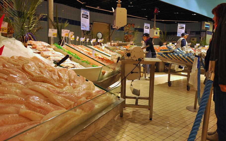 The seafood section at Cora, a giant retail and grocery store in Forbach, France, offers a variety of fresh fish. Customers stand in line and get a ticket to place a fish order.