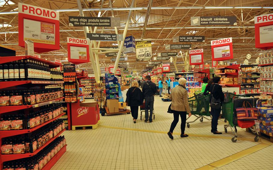 Shoppers walk the aisles at the Cora retail and grocery store in Forbach, France, on Friday, Oct. 2, 2015.