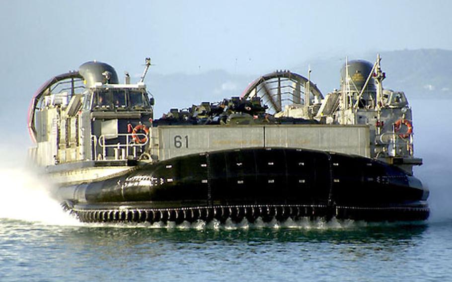 A landing craft, air cushioned — the giant hovercraft the Navy uses to move Marines and gear from ship to shore — closes in to Naval Facility White Beach, Okinawa.