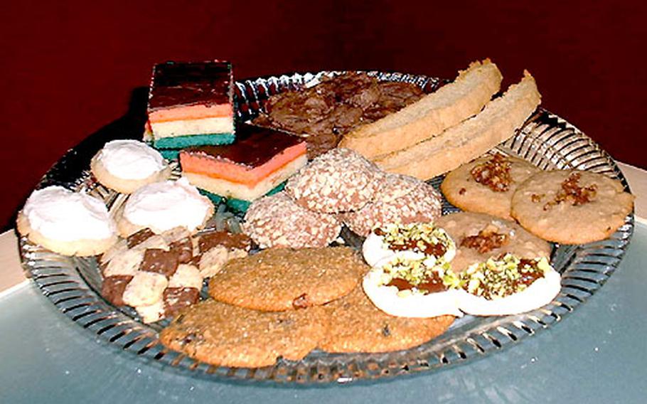 The finalists of the first Stars and Stripes Holiday Cookie Contest include: clockwise from 12 o’clock, Triple Chocolate Chews, Orange-Cinnamon Biscotti, Apple Walnut Surprises, Meringue Fudge Drops, Grit-Rai-Wal Cookies, Chocolate and Orange Checkerboard Squares, Eggnog Cookies, Rainbow Cookies, and center, Almond Roca Cookies. (Snowy Pineapple Bars not pictured.)