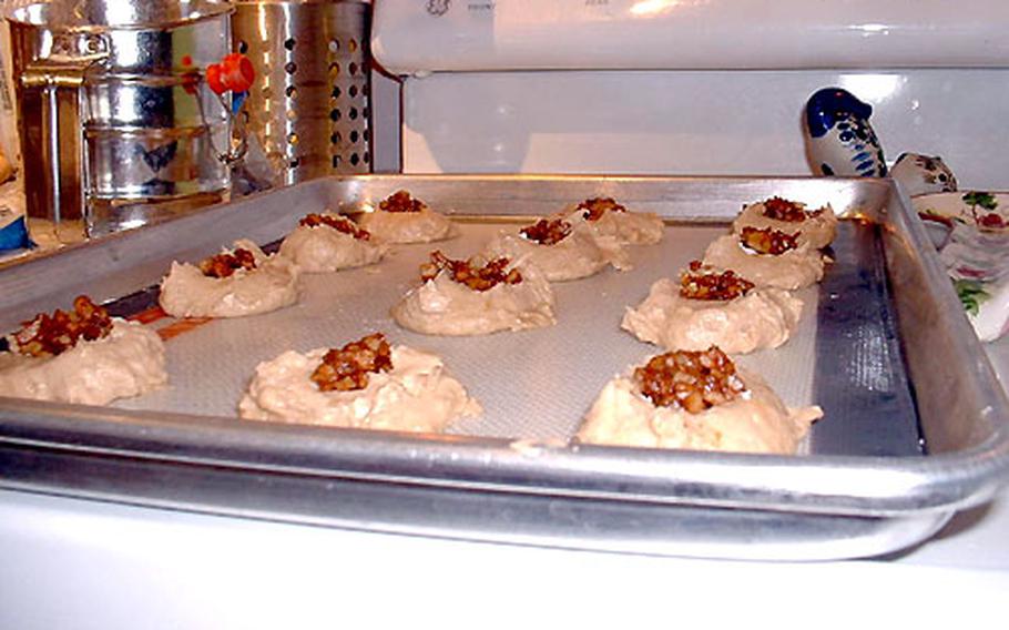 After dropping the Apple Walnut Surprise dough by tablespoon onto a cookie sheet, the filling is spooned on top.