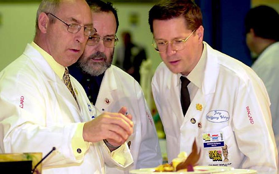 Jury members closely examine a dessert prepared by the U.S. Army Culinary Arts Team.