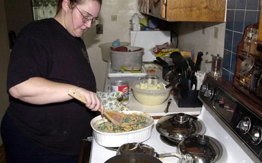 Nicki Barnes puts the final touches on the Thanksgiving meal she prepared for her family and a group of Marines her husband works with.