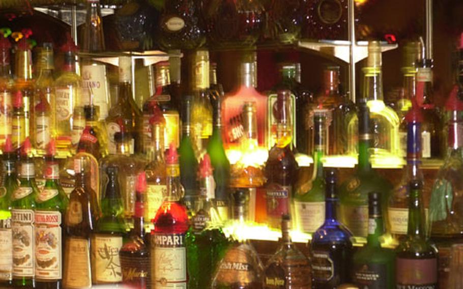 Row upon row of bottles of hard liquor sit behind the bar at the Embarcadero Lounge at the New Sanno Hotel in downtown Tokyo, await customers' requests.