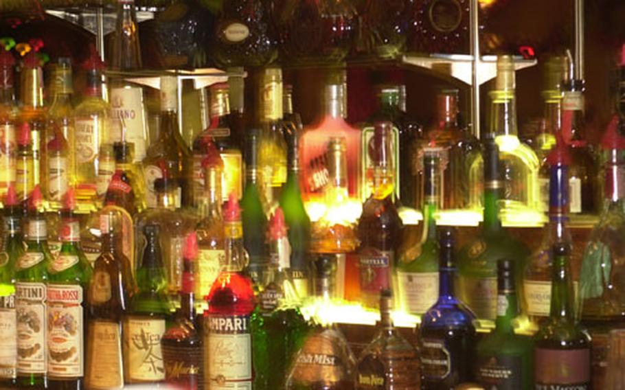 Row upon row of bottles of hard liquor sit behind the bar at the Embarcadero Lounge at the New Sanno Hotel in downtown Tokyo, await customers&#39; requests.