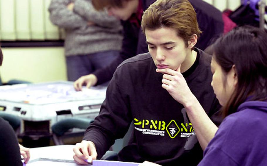 John O’Connor concentrates on a game of mah-jongg. O’Connor is a Nile C. Kinnick High School graduate and the son of a former Marine.