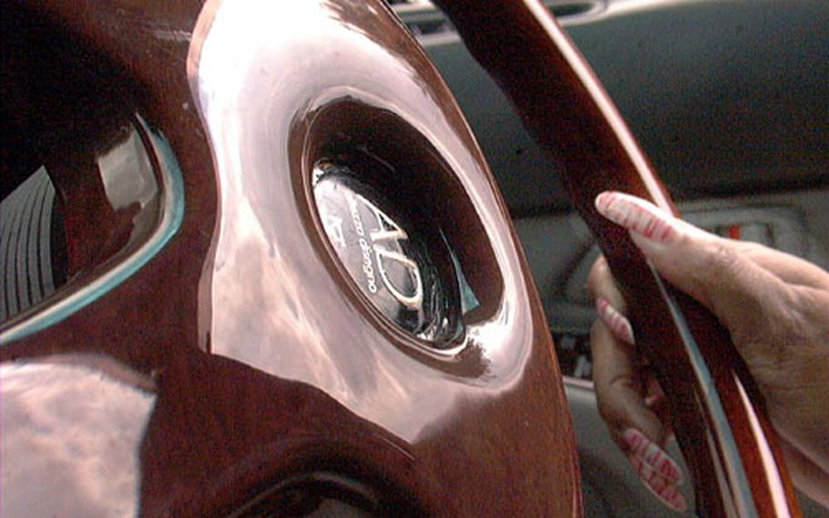 A $200 gleaming mahogany steering wheel is the first of many interior modifications Peaches Jordan has planned for her 1991 Toyota Aristo.