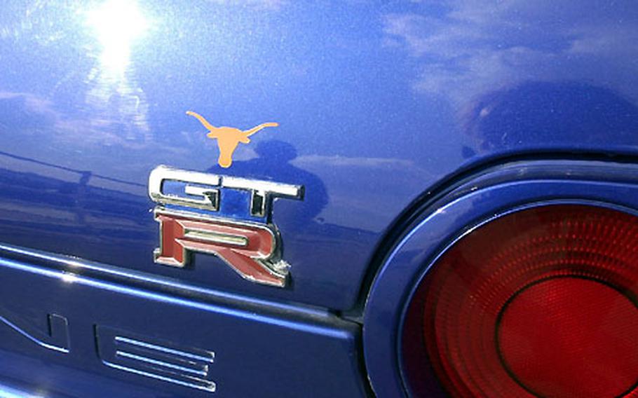 A Texas Longhorn logo is one of the few exterior artwork elements on the shiny ocean-blue 1991 Nissan Skyline R32-GTR owned by Petty Officer 1st Class Aaron Cuzick.