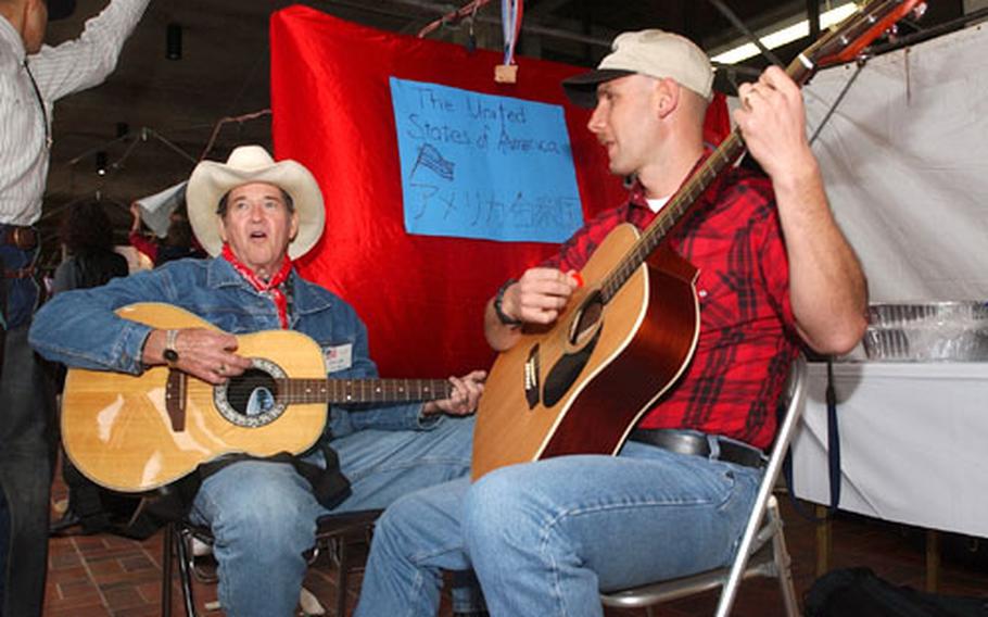Don Cash and Michael Foskett sing classic American country songs to the crowd at the festival. Foskett and several Marines from Camp Schwab volunteered to help run the American booth.
