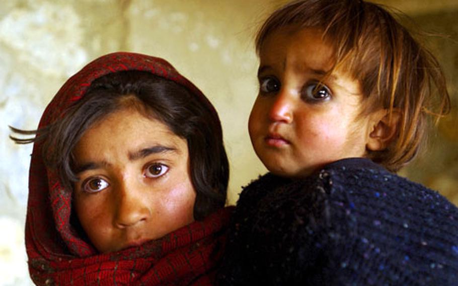 In Tech. Sgt. Stephen Faulisi’s honorable mention-worthy photo in the Portrait category, young Afghan girls wait their turn Dec. 3 to be seen during a Medical Civil Assistance Program held at the village of Deh Baha Ali, Afghanistan.