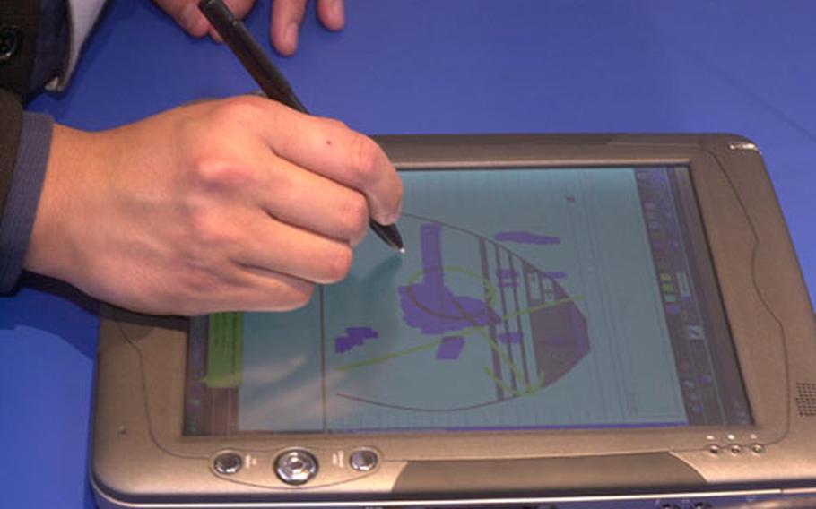 A vendor demonstrates using a specialized "pen" on a tablet computer at the CeBit technology trade show in Hannover, Germany, in March.