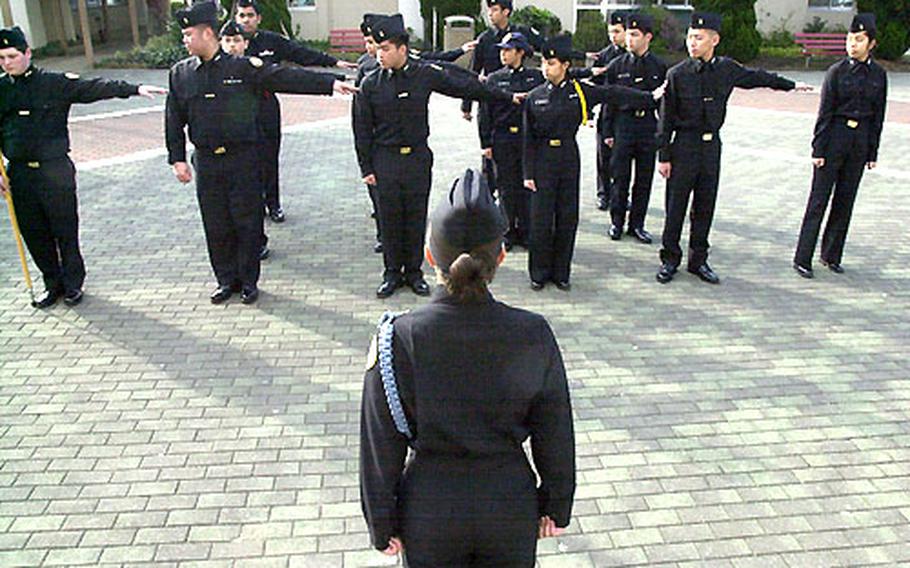 JROTC Cadet Jacqueliyn Guerrero gives the command to dress right to prepare the Kinnick High School JROTC unit for personnel inspection.