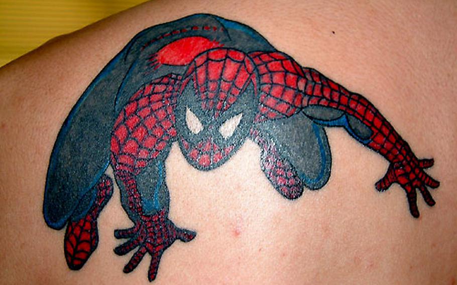 Spiderman crouches pensively on the left shoulder of Osamu Chibana, 28, an Okinawan cook. Chibana got the tattoo five years ago and came to Coko&#39;s for a color touch-up and to add Spidey&#39;s shadow.