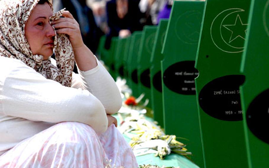 A women cries at the grave of her loved one before the March 31 mass burial in Potocari, Bosnia and Herzegovina.