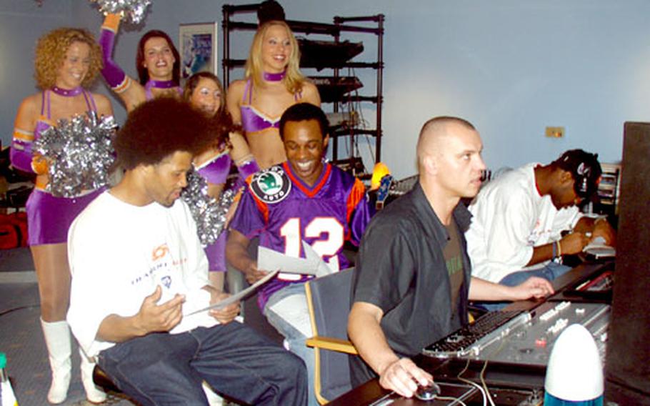 Frankfurt Galaxy cheerleaders Cindy, Jenny S., Sibel, and Anne listen to "Here We Come," as A.K.-S.W.I.F.T., center, ensures everything is flowing. Also pictured are, at far left, Chris Pointer, and at far right, Calvin Spears, Galaxy players; and Paul Schulte, a producer.