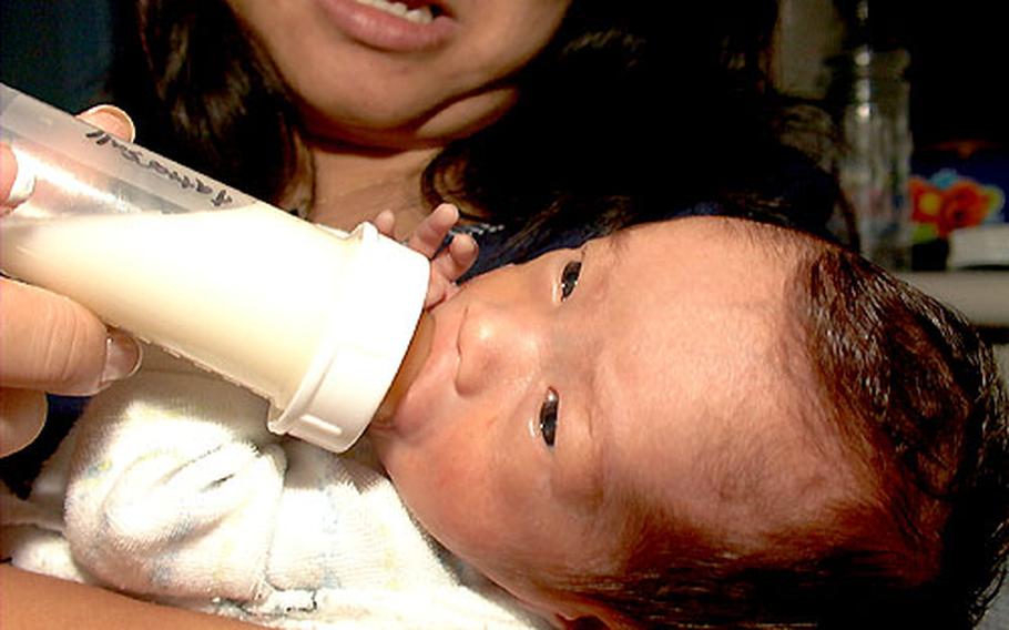 Evan Bradley Tattersall takes his morning feeding from his mother Simone. Evan’s feedings are 2 ounces of breast milk.