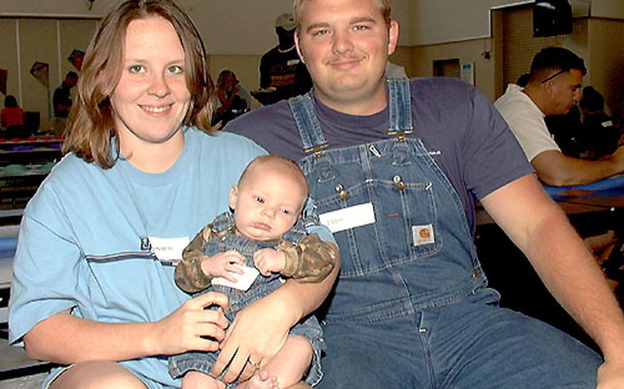 Airman 1st Class Josh Bowlin and his wife Jennifer pose with their 10-week-old son Eli at the Neonatal Intensive Care Unit Reunion. Eli spent a week at the hospital recovering from pneumonia after his birth.