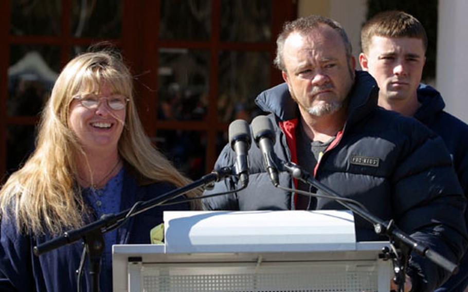 Dee Lynch, mother of Pfc. Jessica Lynch, answers questions about the health and care of her daughter in front of "The Fisher House" at the Landstuhl Regional Medical Center. Pfc. Jessica Lynch was held as a POW in Iraq and has been receiving medical care at LRMC since arriving from Kuwait and Operation Iraqi Freedom. Mr. Lynch and Pfc Greg Lynch, Jr. (father and brother) listen in the background.